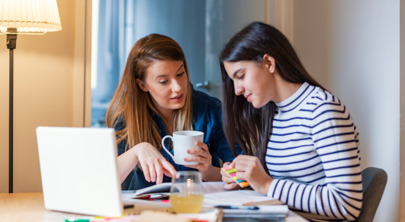 Mum helping teenage girl study